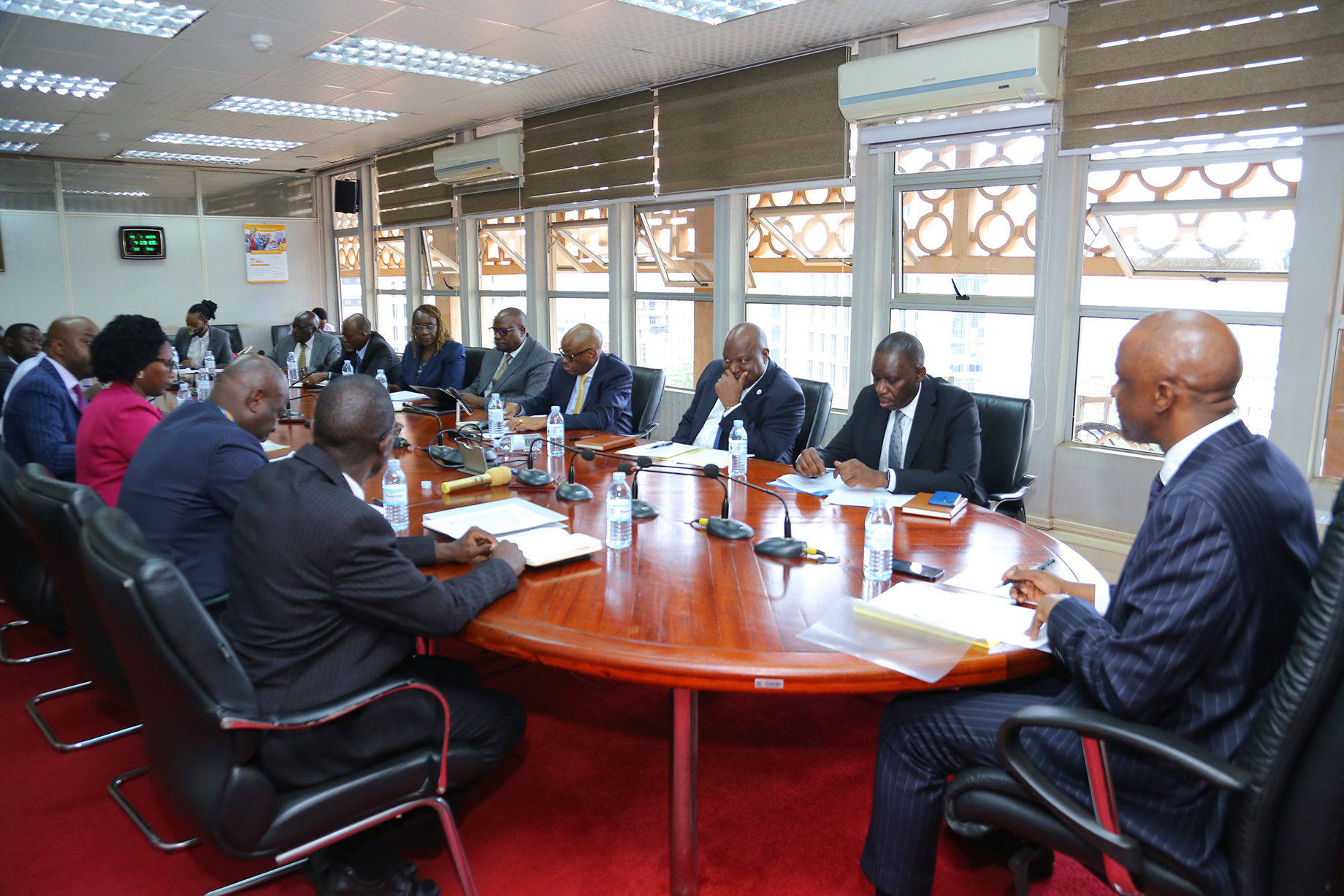 Four of the INVITE Trust Investment Committee members flank on both sides, Mr. Ramathan Ggoobi, PSST and Mr. Michael Atingi-Ego, Governor, BOU, while the fifth member attends virtually, the INVITE Trust meeting held at the Finance Ministry offices on July 15, 2025.